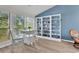 Bright living area featuring a large bookshelf, hardwood floors, dining area, and natural light at 859 Tall Oaks Ct. # A, Myrtle Beach, SC 29588