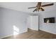 Bright bedroom featuring a ceiling fan, laminate wood floors and a mounted television at 1022 Waccamaw Dr., Conway, SC 29526