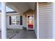 Charming home exterior with a red front door, black shutters, and a welcoming porch at 1049 Augustus Dr., Conway, SC 29527