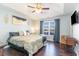 Tranquil primary bedroom with tray ceilings, ceiling fan, and hardwood floors at 1049 Augustus Dr., Conway, SC 29527