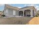 Exterior view of the home with a screened porch and landscaping at 1113 Bluffton Ct., Myrtle Beach, SC 29579