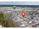 Aerial view of a house in a neighborhood with a pond and amenities center at 190 Goldenrod Circle # 190, Little River, SC 29566