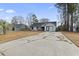 Wide view of the home and driveway, with a well-maintained lawn and lush greenery at 232 Stonebridge Dr., Myrtle Beach, SC 29588