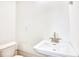 Small bathroom with pedestal sink and toilet at 2409 Causey Dr., North Myrtle Beach, SC 29582