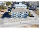 Aerial view of a three-story building with parking and surrounding houses at 300 47Th Ave. S # 1C, North Myrtle Beach, SC 29582