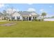 One-story home with white siding, gray roof, and stone accents at 317 Marsh Tacky Loop, Myrtle Beach, SC 29588