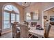 Elegant dining room with a large table, six chairs, and arched window at 3750 Kingsley Dr., Myrtle Beach, SC 29588