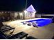 Blue illuminated pool at night with lounge chairs at 3750 Kingsley Dr., Myrtle Beach, SC 29588