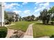 Paved pathway winds through a beautifully landscaped community with lush lawns at 4753 Wild Iris Dr. # 104, Myrtle Beach, SC 29577