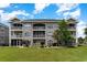 Two-story condo building with stone exterior and screened balconies at 4753 Wild Iris Dr. # 104, Myrtle Beach, SC 29577