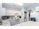 White kitchen with built in microwave and stackable washer/dryer at 4753 Wild Iris Dr. # 104, Myrtle Beach, SC 29577