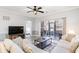 Living room with sectional sofa, TV, and access to screened porch at 4753 Wild Iris Dr. # 104, Myrtle Beach, SC 29577