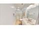 Bright bathroom featuring a large vanity, shower, and mirror at 5300 Ocean Blvd. N, North Myrtle Beach, SC 29582