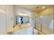 Bright bathroom featuring a large vanity, shower, and mirror at 5300 Ocean Blvd. N, North Myrtle Beach, SC 29582