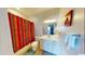 Cozy bathroom with colorful striped shower curtain and ample countertop space at 5300 Ocean Blvd. N, North Myrtle Beach, SC 29582