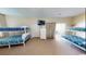 Bright and airy bedroom featuring two sets of bunkbeds, a dresser, and sliding door access to the outside at 5300 Ocean Blvd. N, North Myrtle Beach, SC 29582
