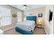 Bright bedroom features a blue headboard, natural light, and modern decor at 5300 Ocean Blvd. N, North Myrtle Beach, SC 29582