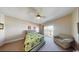 Cozy bedroom with a comfortable sofa, patterned bedding, and balcony access at 5300 Ocean Blvd. N, North Myrtle Beach, SC 29582