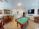 Bright game room includes a pool table, bar seating, and an additional arcade game at 5300 Ocean Blvd. N, North Myrtle Beach, SC 29582