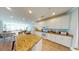 Open-concept kitchen featuring granite countertops, white cabinets, modern appliances and breakfast bar at 5300 Ocean Blvd. N, North Myrtle Beach, SC 29582