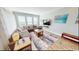 Open concept living room with comfortable seating, a large television, and lots of natural light from large windows at 5300 Ocean Blvd. N, North Myrtle Beach, SC 29582