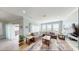 Open concept living room with comfortable seating, a large television, and lots of natural light from large windows at 5300 Ocean Blvd. N, North Myrtle Beach, SC 29582
