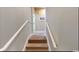 Carpeted staircase with white handrails leading to the upper level of the home at 5300 Ocean Blvd. N, North Myrtle Beach, SC 29582