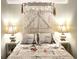 Bedroom with a charming whitewashed headboard and Parisian bedding at 5905 S Kings Hwy. # B130, Myrtle Beach, SC 29575