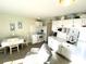 Bright kitchen with white cabinets, appliances, and a dining table at 5905 S Kings Hwy. # B130, Myrtle Beach, SC 29575