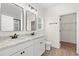 Bathroom featuring double sinks, marble countertops, white cabinets, and a walk-in closet at 800 Caines Landing Rd., Conway, SC 29526