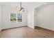 Bright dining area featuring wood floors, wainscoting, contemporary lighting, and a large window at 800 Caines Landing Rd., Conway, SC 29526