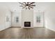 Bright living room with wood floors, a shiplap fireplace, and a ceiling fan, creating a cozy atmosphere at 800 Caines Landing Rd., Conway, SC 29526