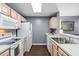 Kitchen with white appliances, wood cabinets, and gray walls at 100 Barnacle Ln. # 4, Little River, SC 29566