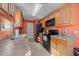 Kitchen with wood cabinets, black appliances, and granite countertops at 117 Burkridge West Dr., Myrtle Beach, SC 29588