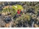 Aerial shot of a property surrounded by trees and nearby golf course, showcasing its serene and private setting at 118 Oatland Lake Rd., Pawleys Island, SC 29585