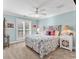 Charming bedroom with floral bedding, ceiling fan, and light blue walls at 118 Oatland Lake Rd., Pawleys Island, SC 29585