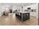 Open concept kitchen with island and view into living area at 1262 Witch Hazel Way, Longs, SC 29568