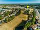 An aerial view showcasing the house in a community surrounded by a golf course and water features at 127 Marauder Dr., Longs, SC 29568