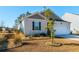 Well-kept single-story home with a one-car garage, manicured lawn, rock beds and decorative shrubbery at 127 Marauder Dr., Longs, SC 29568