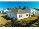 Rear view of a tan house with fenced yard at 127 Marauder Dr., Longs, SC 29568