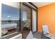 Open sliding door to the balcony with chairs to see a bedroom and ocean view at 1501 S Ocean Blvd. # 1442, Myrtle Beach, SC 29577
