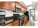 Full kitchen featuring stainless steel appliances, granite countertops, and wooden cabinets at 1501 S Ocean Blvd. # 1442, Myrtle Beach, SC 29577