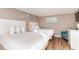 Cozy bedroom featuring two beds, a dresser, and beach-themed paintings at 1501 S Ocean Blvd. # 1549, Myrtle Beach, SC 29577