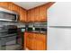 Galley kitchen features stainless steel appliances, wood cabinets, and stone countertops at 1501 S Ocean Blvd. # 1549, Myrtle Beach, SC 29577