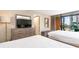 Relaxing bedroom with TV, balcony access, and comfortable sleeping arrangements at 1501 S Ocean Blvd. # 251, Myrtle Beach, SC 29577