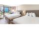 Comfortable bedroom showcasing two beds, a balcony, and relaxing natural light at 1501 S Ocean Blvd. # 251, Myrtle Beach, SC 29577