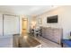 Open-concept living area featuring dining area, modern TV, and convenient murphy bed at 1501 S Ocean Blvd. # 251, Myrtle Beach, SC 29577