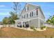 Two-story home with a white pergola and landscaped yard at 22 Trigger Fish Ln., Murrells Inlet, SC 29576