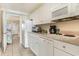 Efficient galley kitchen with white cabinets, appliances, and tile floor at 2406 N Ocean Blvd. # 604, Myrtle Beach, SC 29577