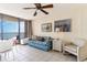 Living room with ocean view, sofa, and ceiling fan at 2406 N Ocean Blvd. # 604, Myrtle Beach, SC 29577